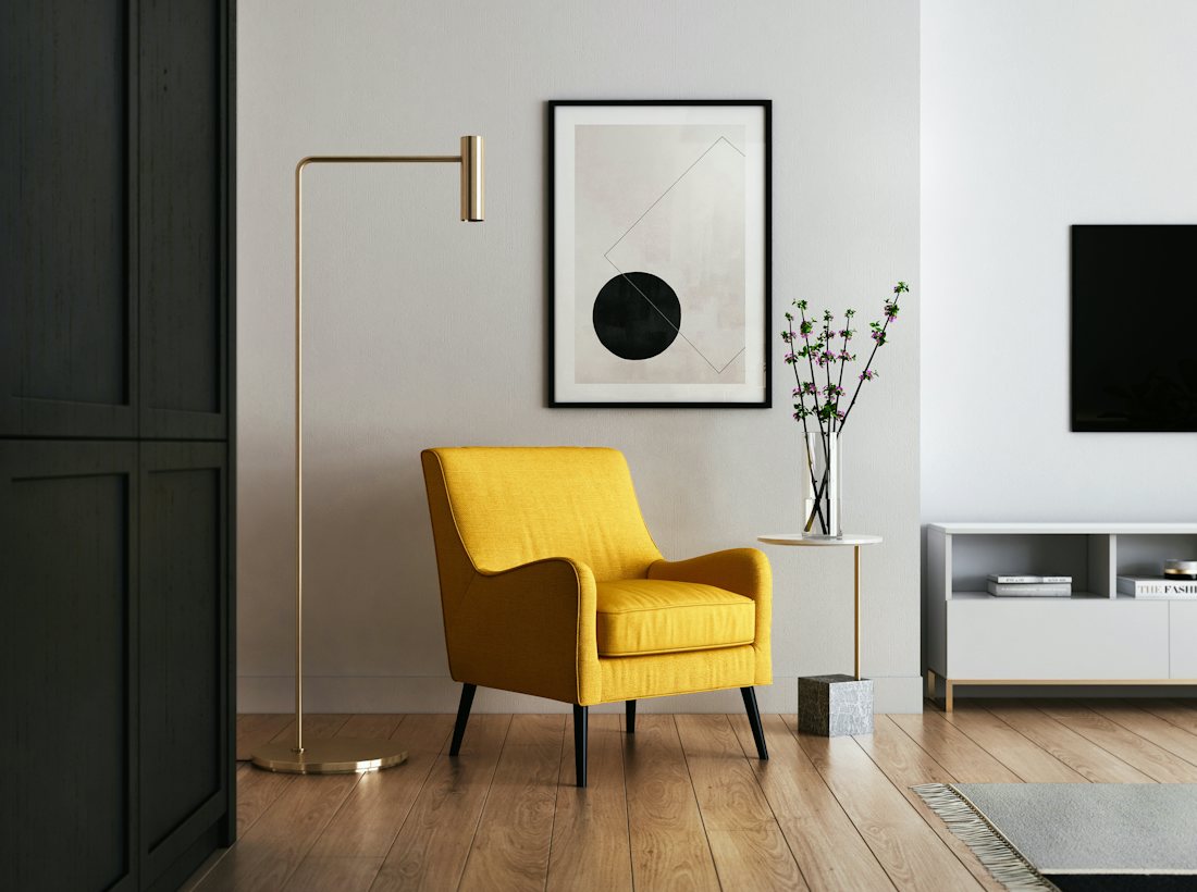 A tidy living room with a yellow armchair in a newly moved-into home