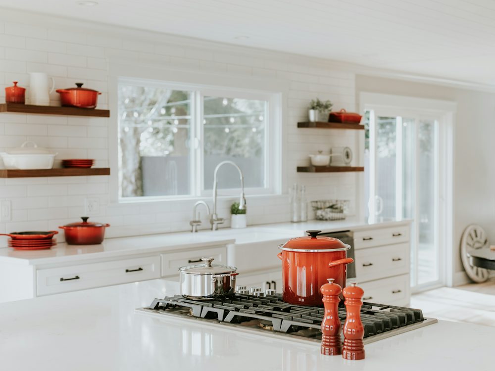 A bright kitchen with open shelving and cookware